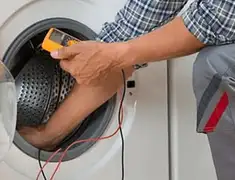 Washing machine repair technician testing a front-load washer with diagnostic tools in Philadelphia, PA
